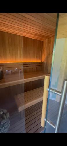 a room with a sauna with a glass door at Glamping & Spa Luna Azzurra in Sulmona