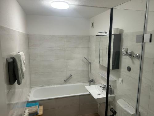 a bathroom with a tub and a sink and a shower at Ferienwohnung Truckses Schluchsee in Schluchsee