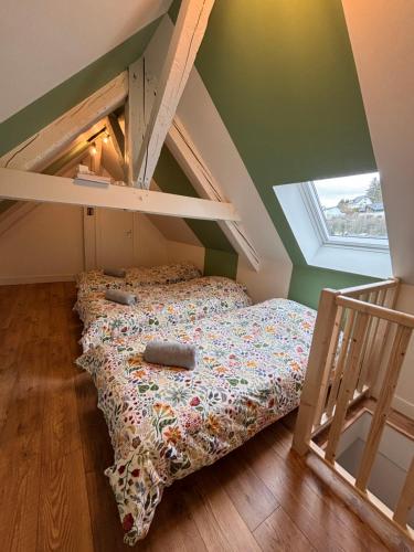 a bed in a room with a loft at Résidence la Plage in La Bourboule