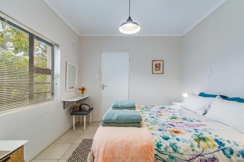 a bedroom with a bed and a window at Barnacle Tree in Somerset West