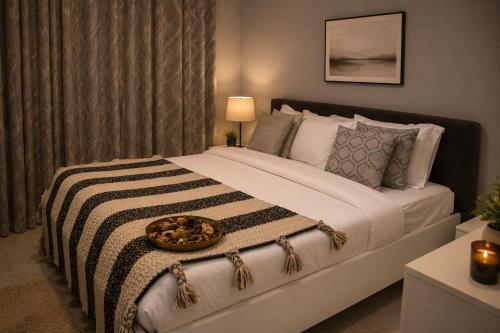 a bedroom with a large bed with a bowl on it at Care Appartement in Kinshasa