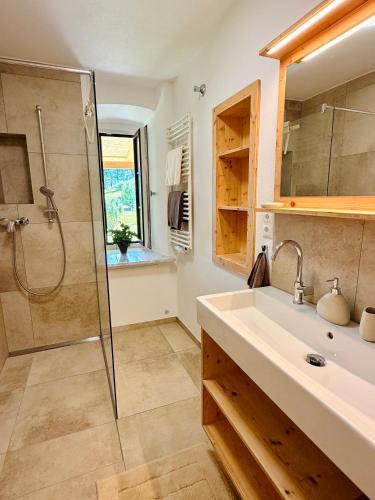 a bathroom with a sink and a shower at Beim Mühltaler III in Schleching