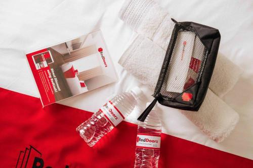 a suitcase and a bottle of toothpaste and a toothbrush at Hoya Residence Syariah in Sodong