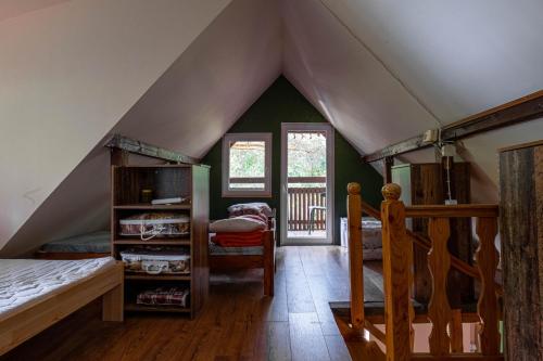 a bedroom with a tent with a bed and a chair at Mchowa Chata in Słupia