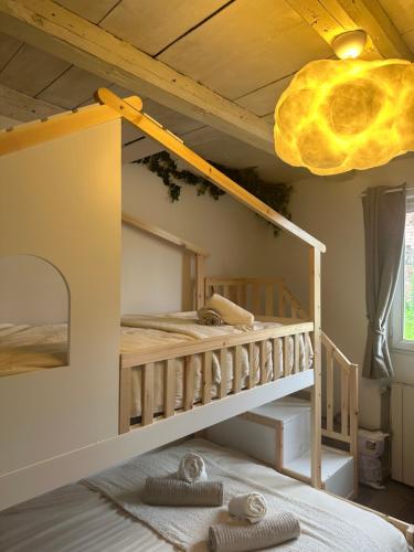 a bedroom with a bunk bed and a crib at La Cabane in Dambach-la-Ville