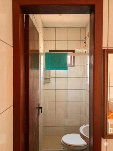 a bathroom with a toilet and a sink at Residencia Siqueira in Garopaba