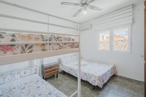 a bedroom with two bunk beds and a window at Pisito de Pueblo I I in Navaluenga