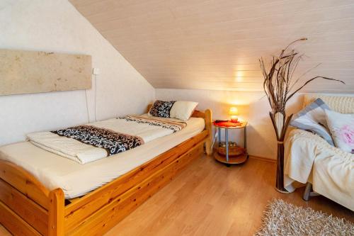a small room with two beds in a attic at Ferienwohnung Zum Leiselsee in Baunatal