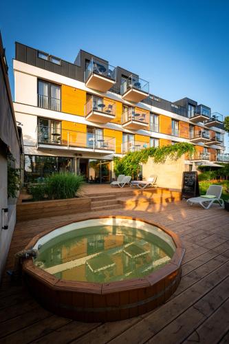 a building with a pool in front of a building at Hotel Uniejów in Uniejow