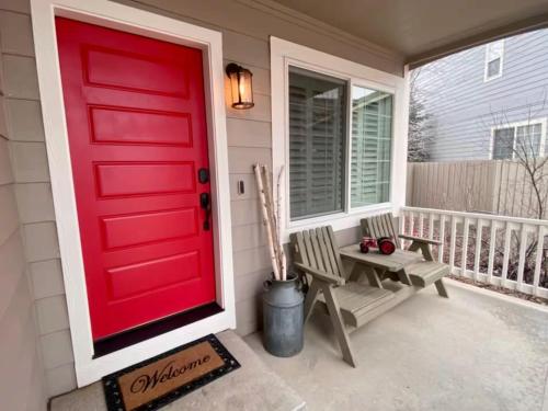 a red door on a house with a bench at BoCo Bungalow in Superior
