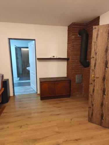 a room with a brick wall and a wood floor at Motoráj -apart Kutná Hora in Kutná Hora