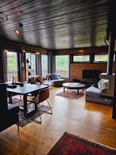a living room with a table and couches at Beautiful apartment in Sinnes E12 in Dirdal