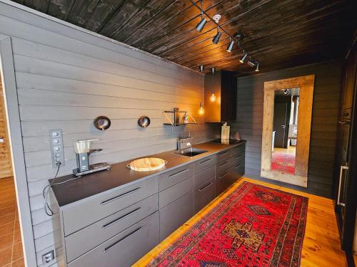 a bathroom with two sinks and a red rug at Beautiful apartment in Sinnes E12 in Dirdal