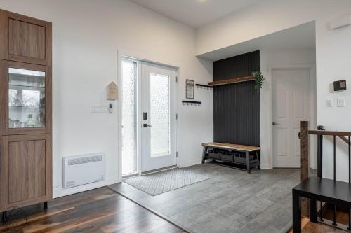 an empty living room with a door and a table at Ours noir spa waterfront in Chertsey
