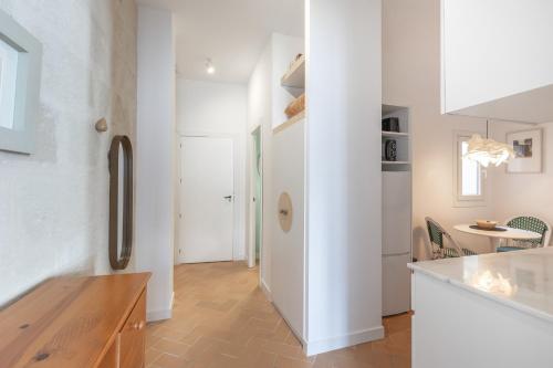 a kitchen with white walls and a white refrigerator at Suite 2 in Mahón