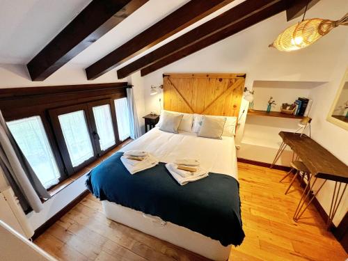 a bedroom with a large bed with a wooden headboard at La Cristalina in Prado