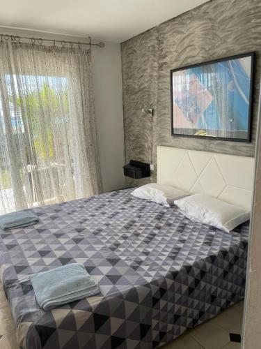 a bedroom with a large bed with a tv on the wall at Valentina Platja in Sant Antoni de Calonge