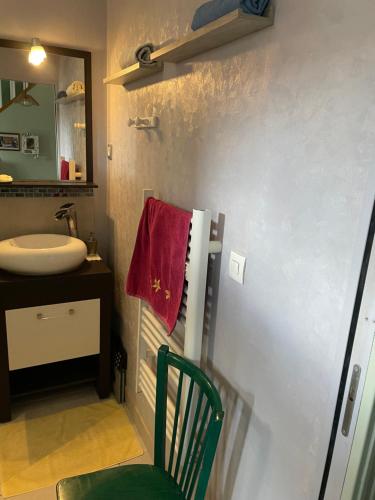 a bathroom with a sink and a red towel at Maison avec balcon in Saint-Hilaire-Petitville