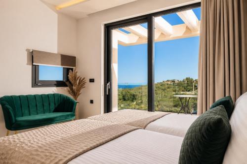 a bedroom with a bed and a large window at Villa Vatia 3 in Tragaki
