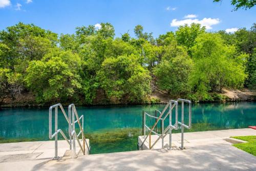 a view of a river with two metal gates at Shared Hot Tub & Pool Grill River Access in New Braunfels
