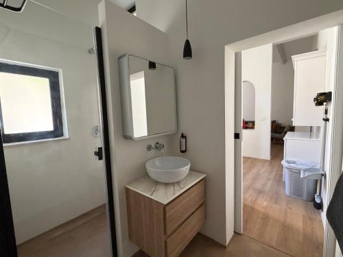 a bathroom with a sink and a mirror at Cosy home in Three Cities in Taʼ Penza
