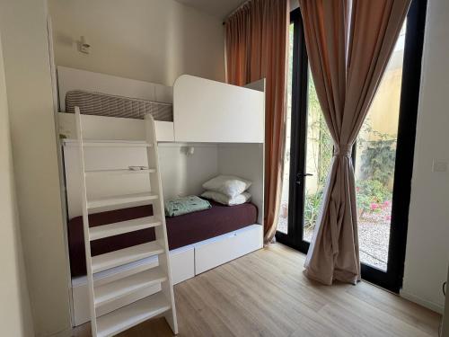 a bunk bed in a room with a window at Cosy home in Three Cities in Taʼ Penza