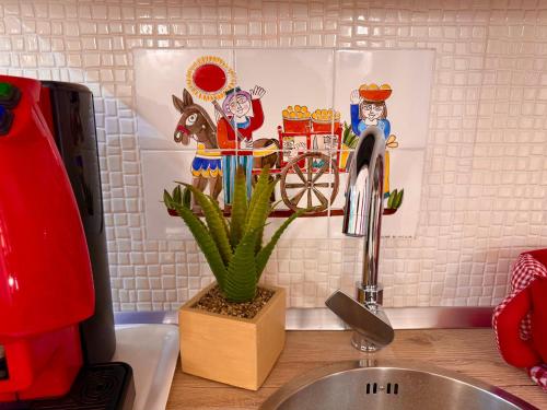 a kitchen counter with a sink and a faucet at Le Chalet Palermo Centro in Palermo