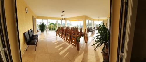 a dining room with a table and chairs in a building at Villa melys in Petite Île