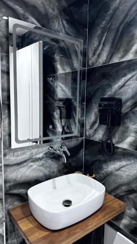 a bathroom with a white sink and a mirror at Vila Klea in Ksamil