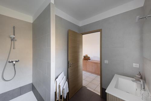 a bathroom with a sink and a shower at Hôtel Maristella in Algajola