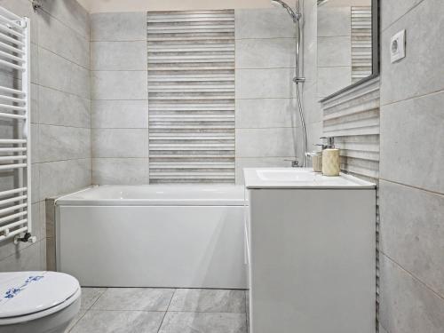 a white bathroom with a toilet and a sink at Konstanzer 44 - Urban Studio - Iulius Mall - AC in Iaşi