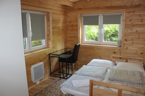 a room with two beds and a desk in a cabin at Chalet Lohr in Lohr