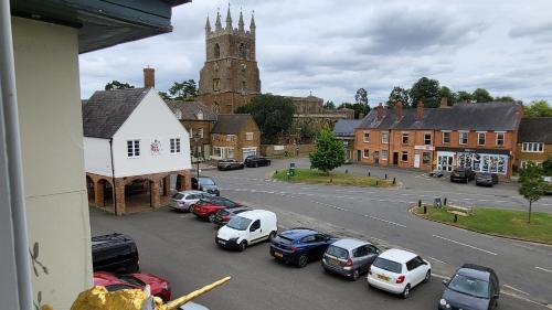 a view of a town with cars parked on a street at Unicorn Inn in Deddington