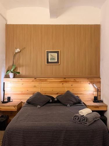 a bedroom with a bed with a wooden wall at 509 Accommodation in Oaxaca City