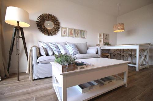 a living room with a couch and a table at Santa Ana 22 by homeprive in El Verger