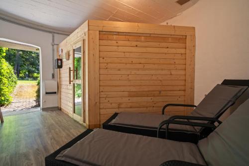 a room with two beds and a wooden wall at Ferienhaus Träumerei am Plauer See in Alt Schwerin