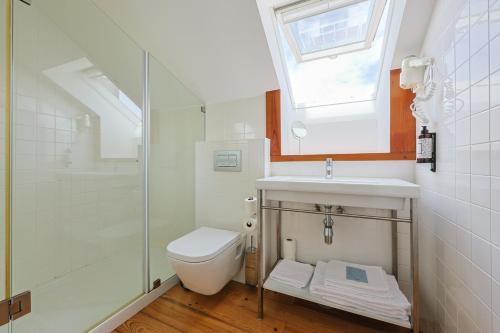 a bathroom with a toilet and a sink and a shower at Casa de São Bento by PURUS in Coimbra