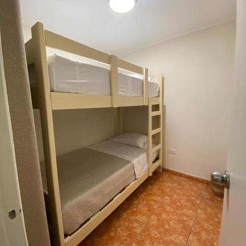 a bedroom with two bunk beds in a room at La casa del cuadro in Lima