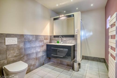 a bathroom with a toilet and a sink and a shower at Maison Françoise in Monpazier
