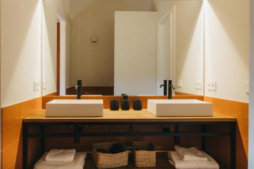 a bathroom with two sinks and a mirror at SON MARTORELL by BookMenorcaVillas Unique country house in Mahón