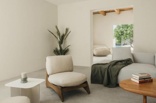 a living room with a bed and a chair at SON MARTORELL by BookMenorcaVillas Unique country house in Mahón