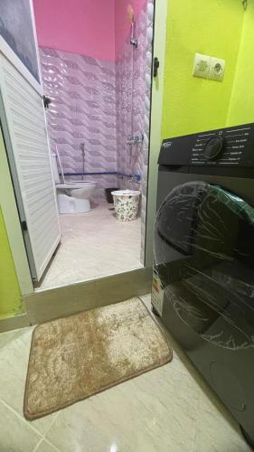 a bathroom with a door open to a bathroom with a tub at MRIRT Home N4 in Jemaa de Mrirt