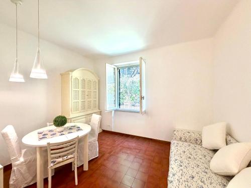 a living room with a white table and a window at Excelsior Relaxing Apartment in Levanto