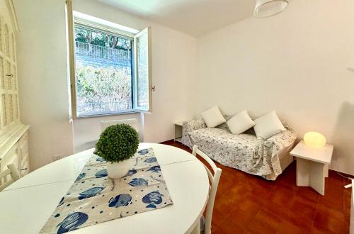 a living room with a table and a couch at Excelsior Relaxing Apartment in Levanto
