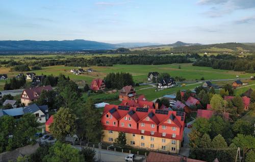 an aerial view of a town with houses and trees at Ośrodek Wczasowy Groń Placówka in Białka Tatrzańska