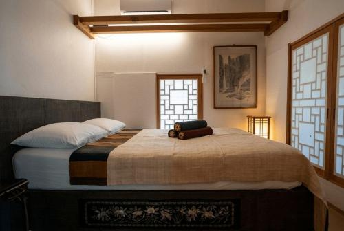 a bedroom with a large bed with a teddy bear on it at Andong GyeongHamjeong in Andong