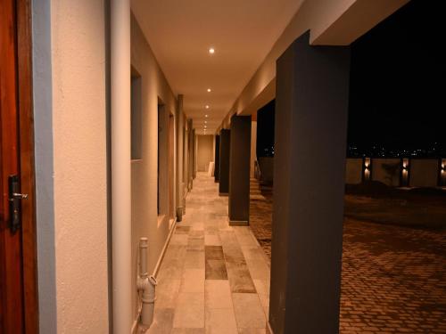 a hallway of a building at night with lights at Gae Ga Monare Guest House in Burgersfort