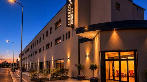 a building on a street at night with lights at LVG Hotel Collection - Belfiore in Mantova