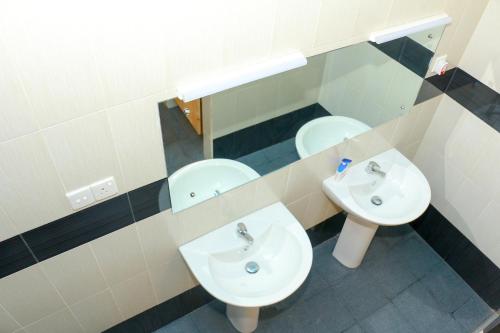 a bathroom with two sinks and two toilets at Villa 92 City Stay in Kandy