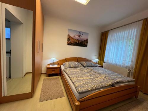 a bedroom with a bed and a large window at Ferienwohnung Stani in Leibnitz